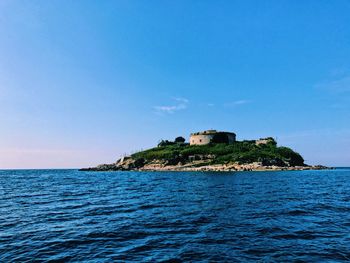 Scenic view of sea against clear blue sky