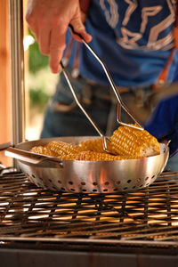 Midsection of person preparing food in kitchen