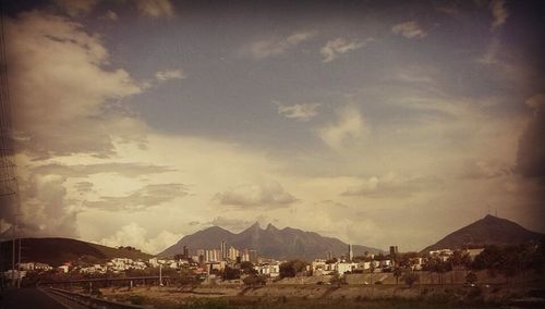 Scenic view of mountains against cloudy sky