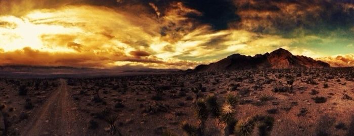 Scenic view of mountains against cloudy sky