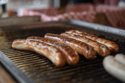 Close-up of sausages on barbecue at market for sale