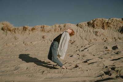 Full length of man standing on beach