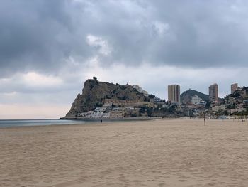 Built structure on beach against sky