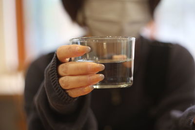 Midsection of man holding drink