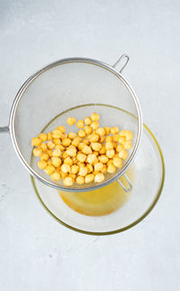 Chickpea water aquafaba. egg replacement. vegan concept. metal sieve 