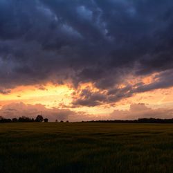 Scenic view of landscape against cloudy sky