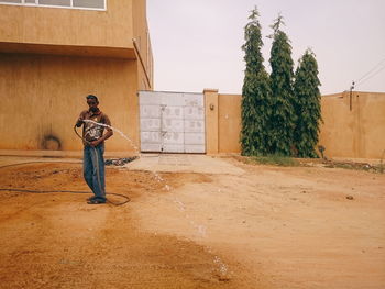 Full length of man standing by tree