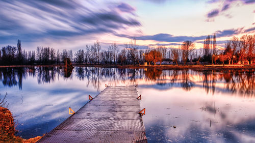 Scenic view of lake against sky during sunset