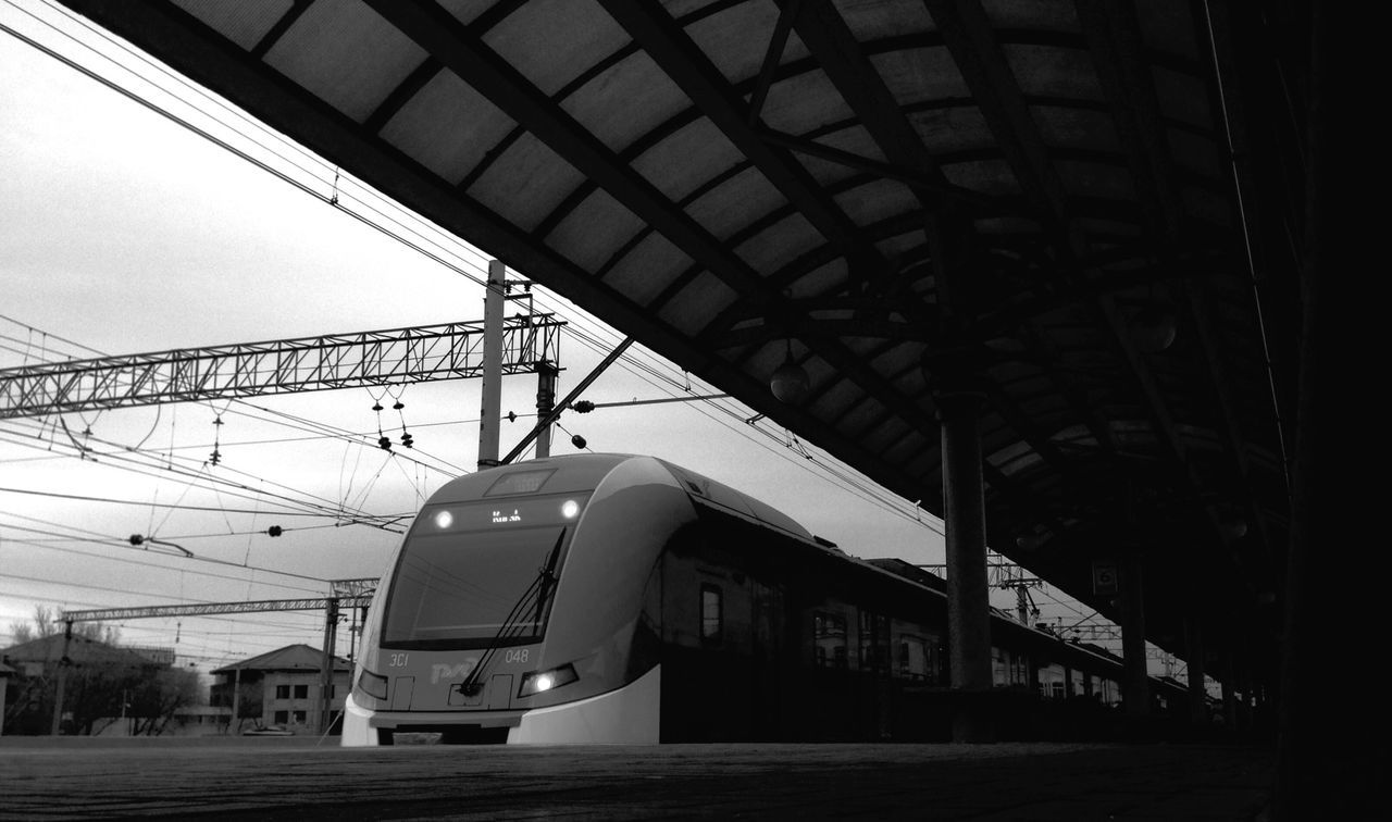 architecture, built structure, building exterior, low angle view, indoors, ceiling, connection, modern, technology, building, city, transportation, day, electricity, no people, power line, cable, sky, railroad station, incidental people