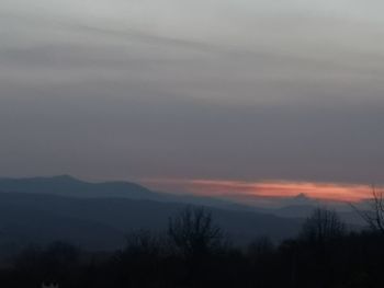 Scenic view of silhouette mountains against sky at sunset