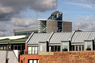 Roof of building against cloudy sky