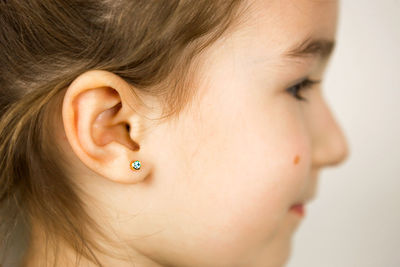 Close-up girl looking away against white background