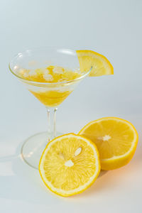 Close-up of drink on glass against white background