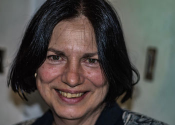 Close-up portrait of smiling mature woman at home