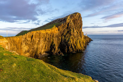 Scenic view of cliff by sea