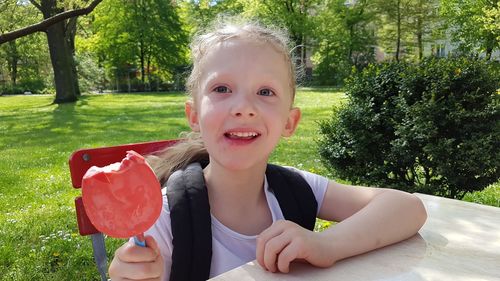 Portrait of cute girl standing in park