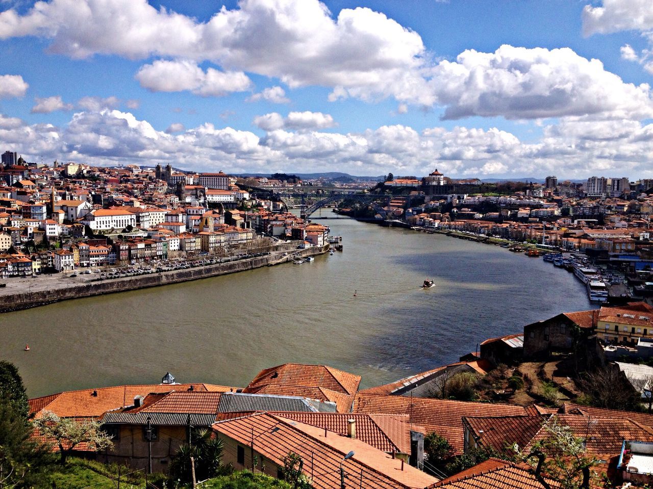 architecture, building exterior, built structure, cityscape, city, water, sky, high angle view, residential district, crowded, residential structure, town, river, residential building, cloud - sky, townscape, house, roof, cloud, sea