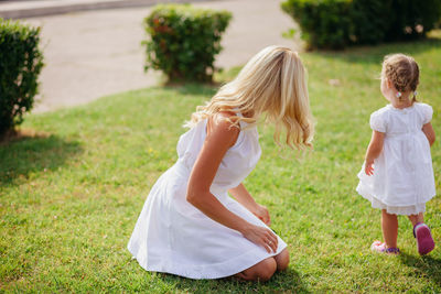 Rear view of two girls on grassland