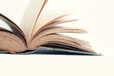 Close-up of open book against white background