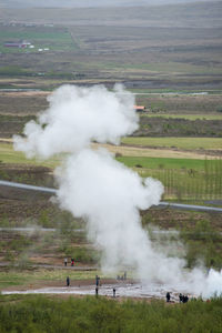 Tourists visiting and waiting for the eruption of strokkur geyser in the golden circle of iceland