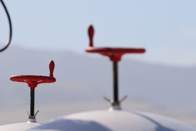 Close-up of red umbrella against clear sky