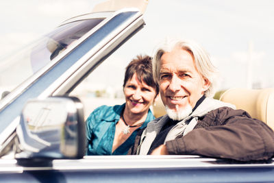 Portrait of smiling man and woman sitting in bus