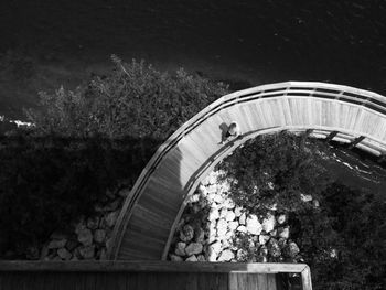 High angle view of man walking on footbridge by river