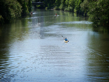 Man on kayak at ihme river amidst trees