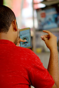 Rear view of man using mobile phone
