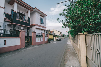 Street amidst buildings against sky