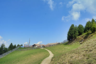 Panoramic view of road amidst trees and buildings against sky