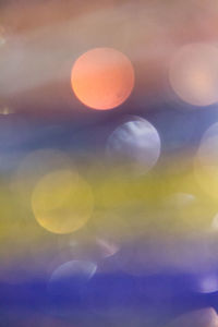 Close-up of yellow moon against sky at sunset