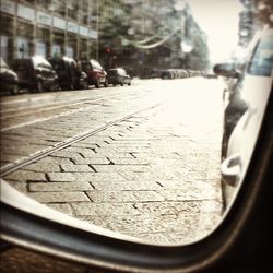 Close-up of car on road