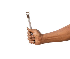 Close-up of man holding hands against white background