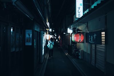 Man in illuminated city at night