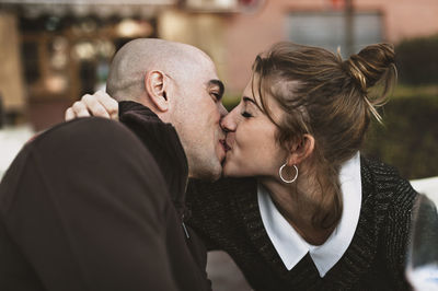 Close-up of couple kissing outdoors