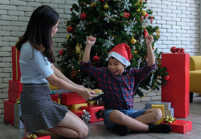 Women sitting on christmas tree