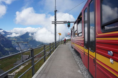 Train moving on railroad tracks against sky