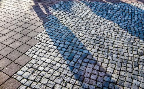 Shadow of people on footpath