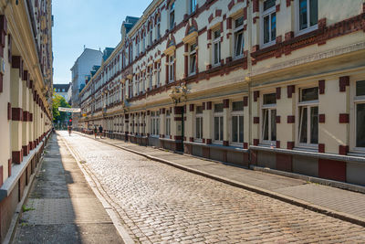 Street amidst buildings in city against sky