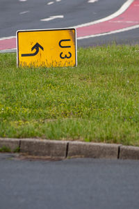 Yellow arrow sign on road