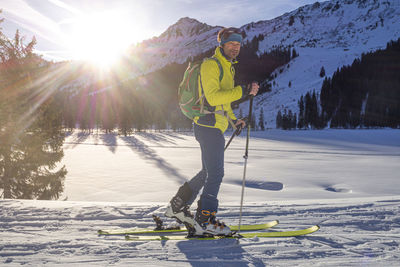 Person skiing on snow against mountain range