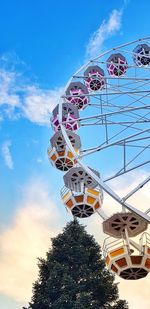 Low angle view of ferris wheel against sky