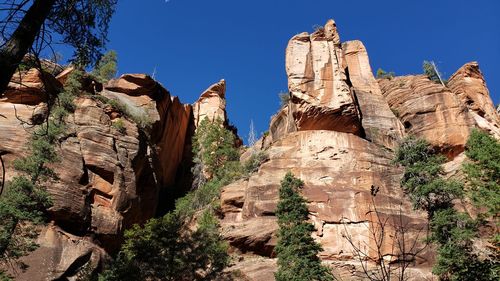 Low angle view of rock formation against sky