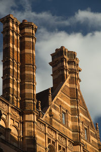 Low angle view of building against cloudy sky