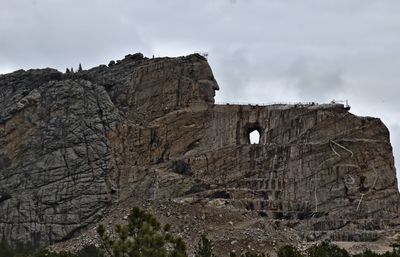 Low angle view of rock formation on mountain against sky