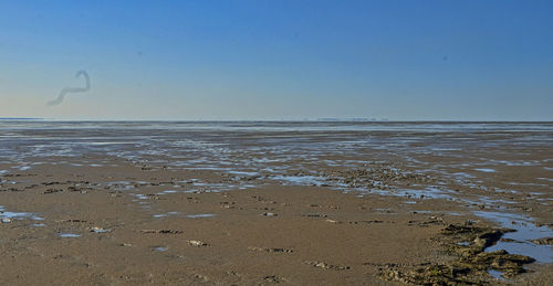 Scenic view of beach against clear sky