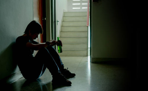 Side view of a woman using mobile phone