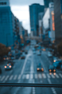 Vehicles on road amidst buildings in city