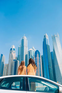 Low angle view of modern buildings against blue sky